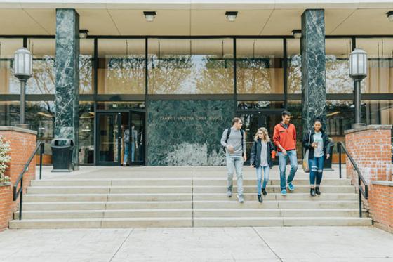 Photo of four Chatham students exiting the library on the University's Shadyside Campus.